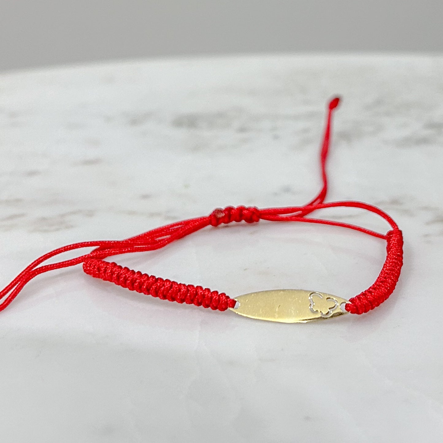 Pulsera tejida hilo con placa oval oro 18k