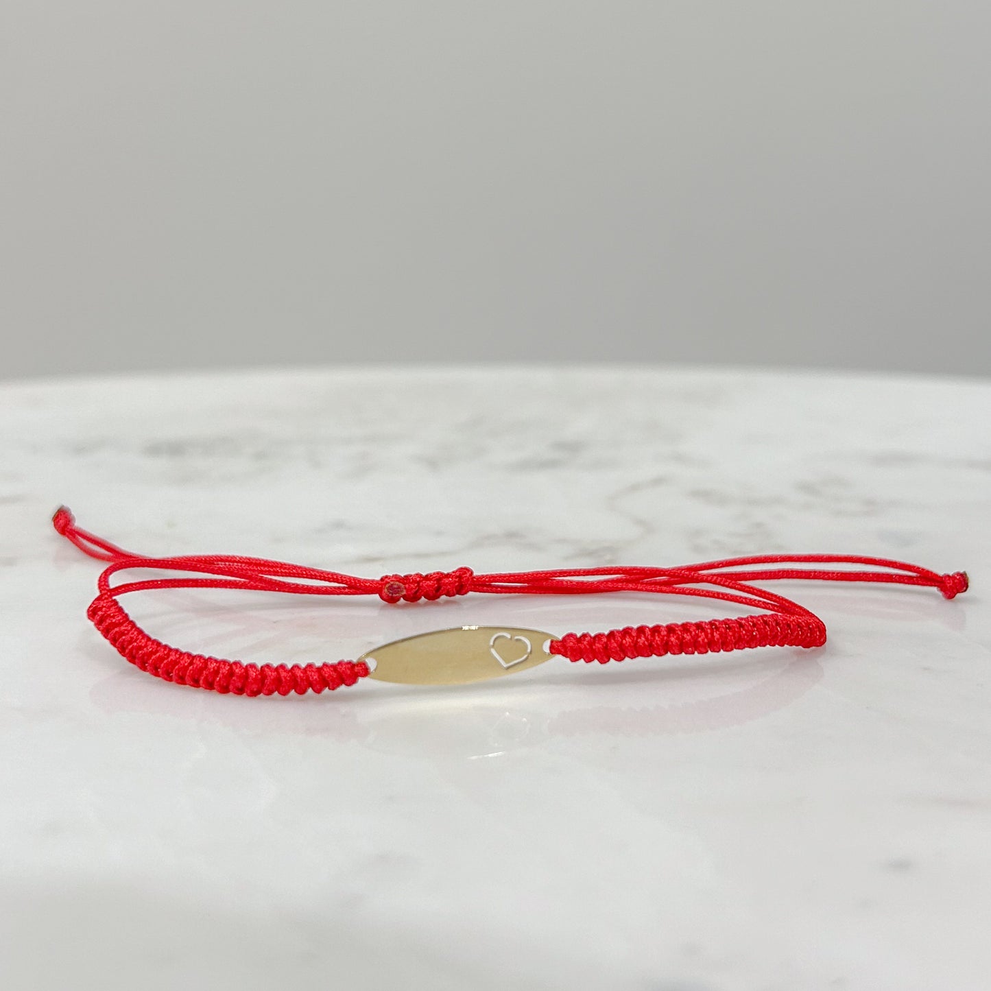 Pulsera tejida hilo con placa oval oro 18k