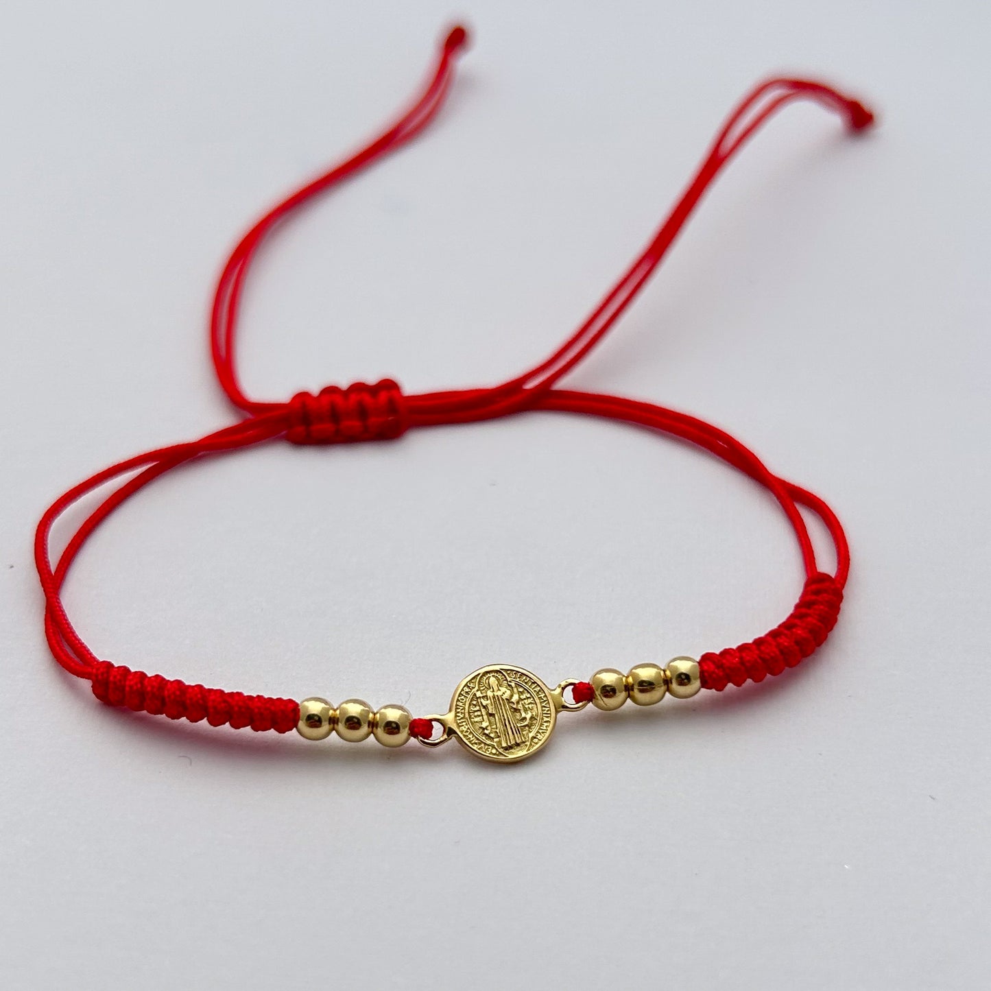 Pulsera tejida de San Benito en Oro18k