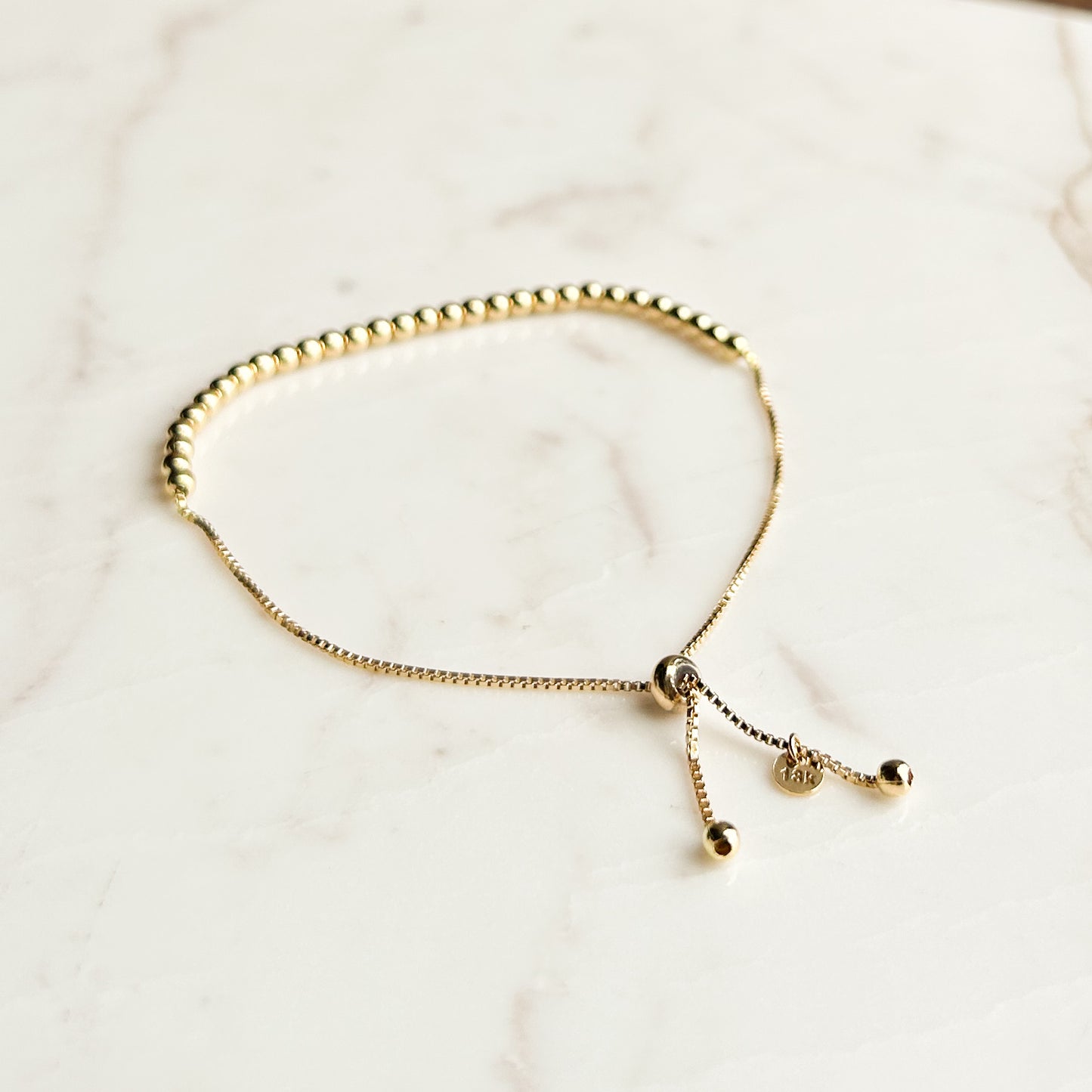 Pulsera bolitas regulable oro 18k
