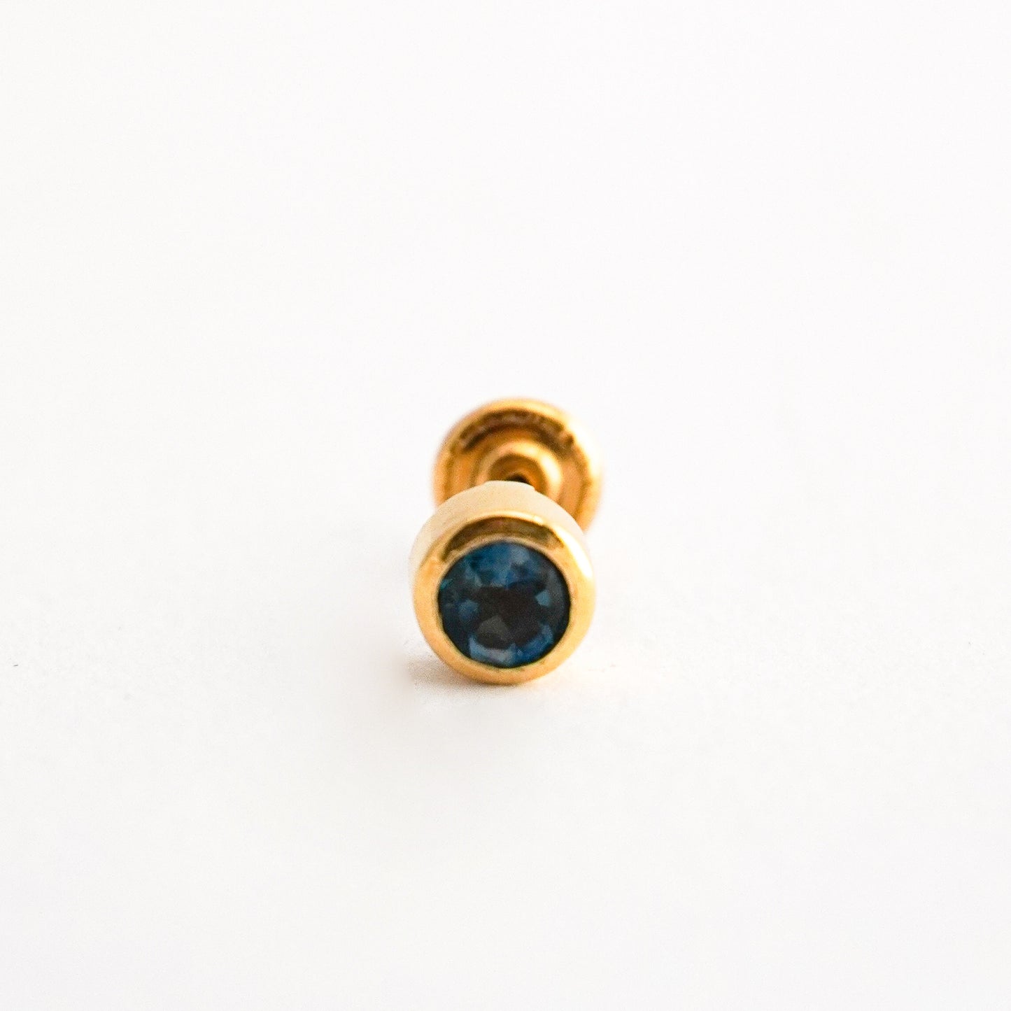 1/2 Arete de bebé en Oro18k con piedra natural topacio london blue Oro18k