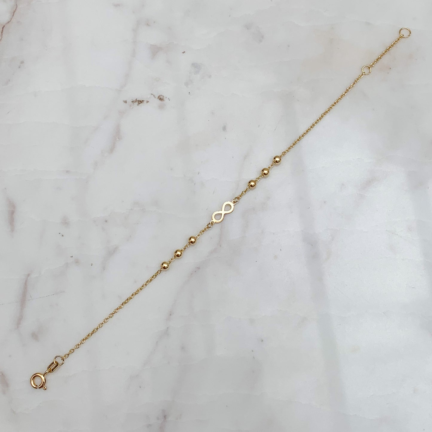Pulsera Infinito con Bolitas en Oro 18K