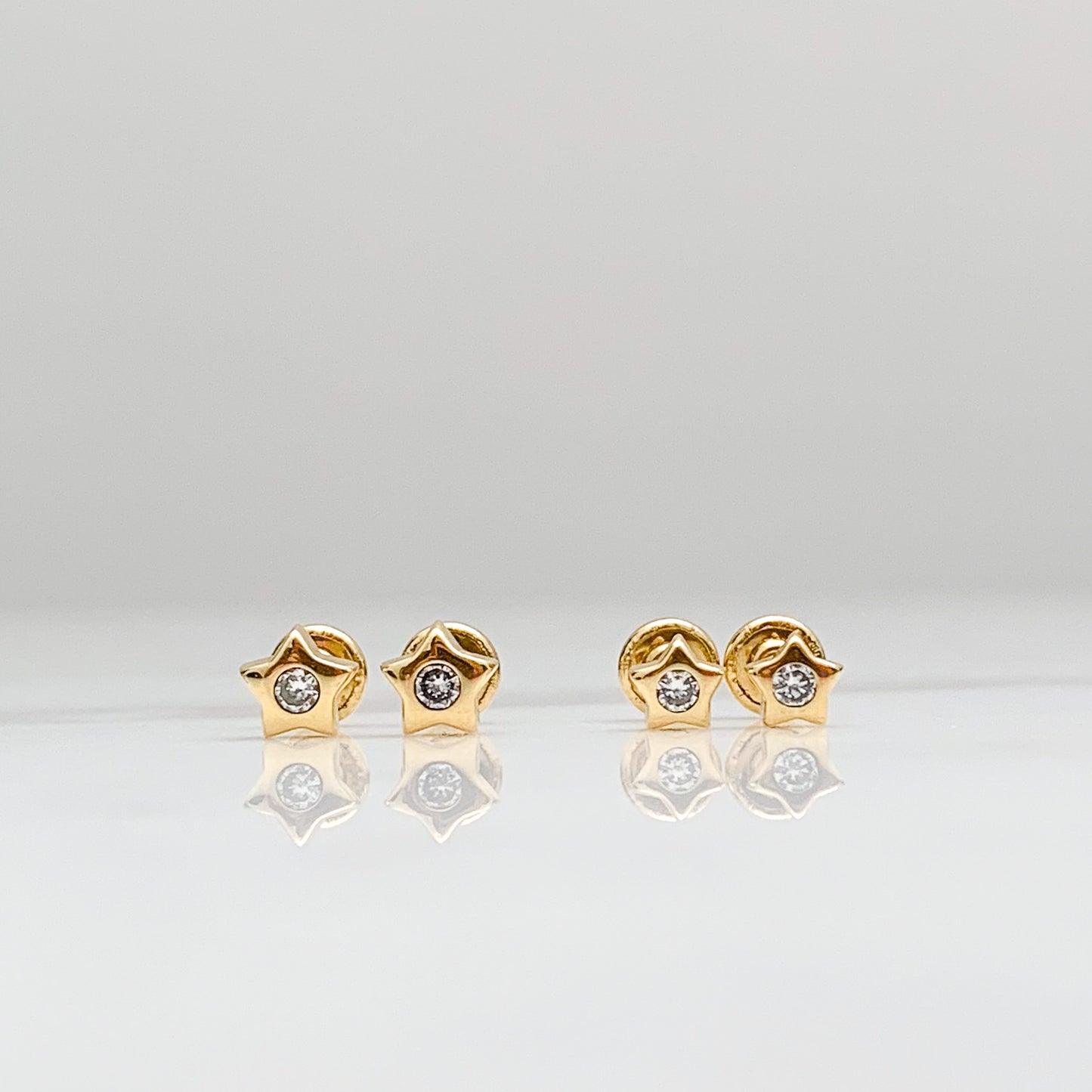 Aretes bebé estrella con circón brillante en Oro18k