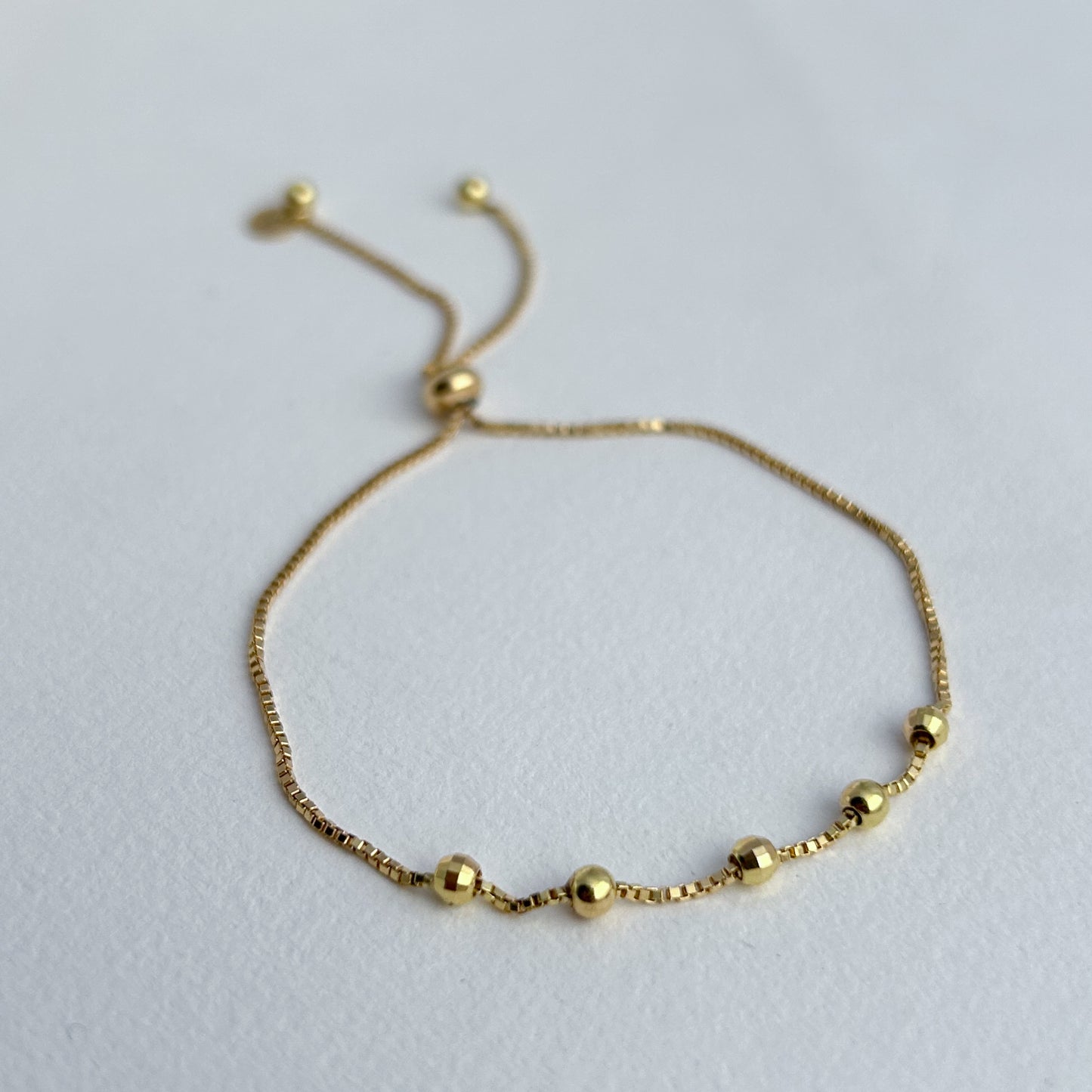 Pulsera 5 bolitas regulables oro 18k