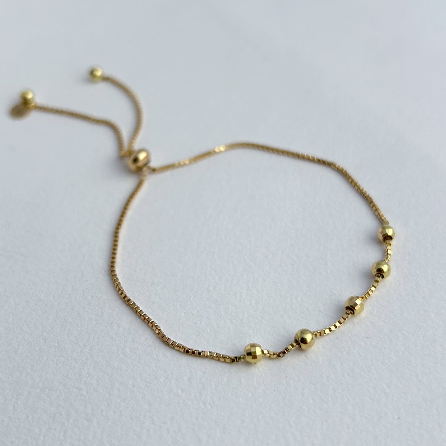 Pulsera 5 bolitas regulables oro 18k