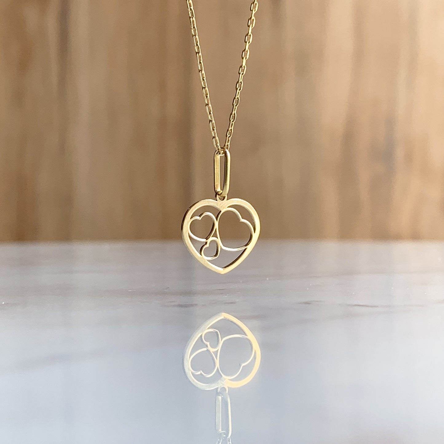 Dije corazones unidos de Oro18k