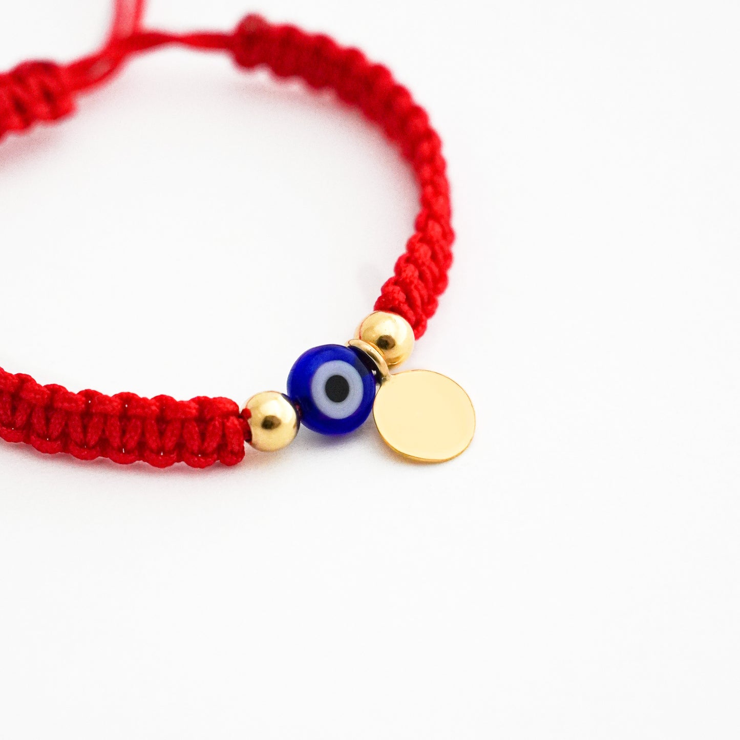 Pulsera tejida protectora con ojo turco y placa en Oro18k