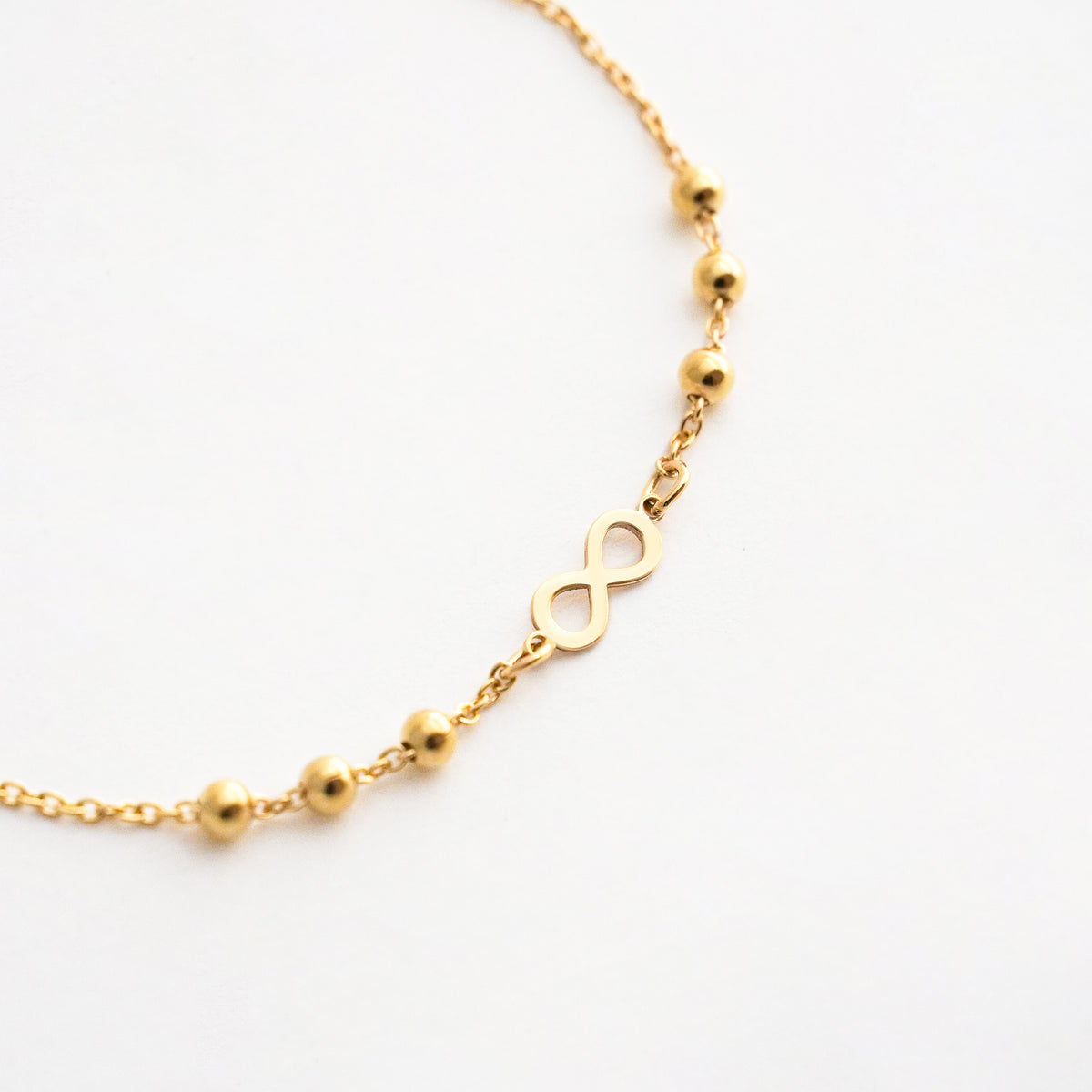 Pulsera Infinito con Bolitas en Oro 18K