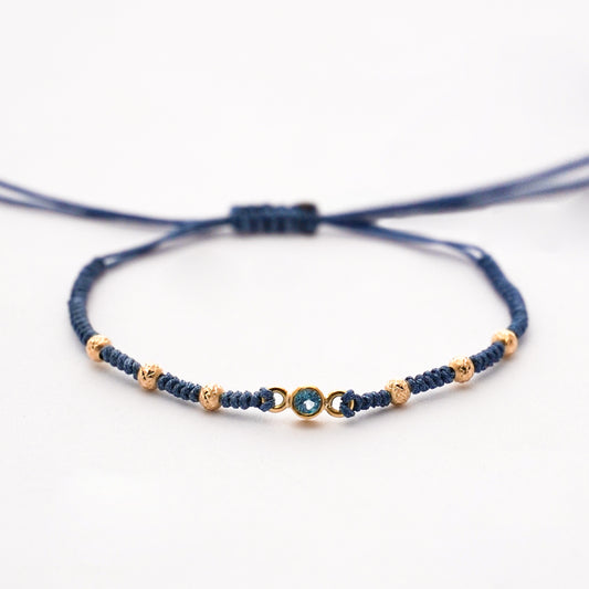Pulsera tejida blue line con bolitas diamantadas 2.5 mm y topacio natural en Oro18k