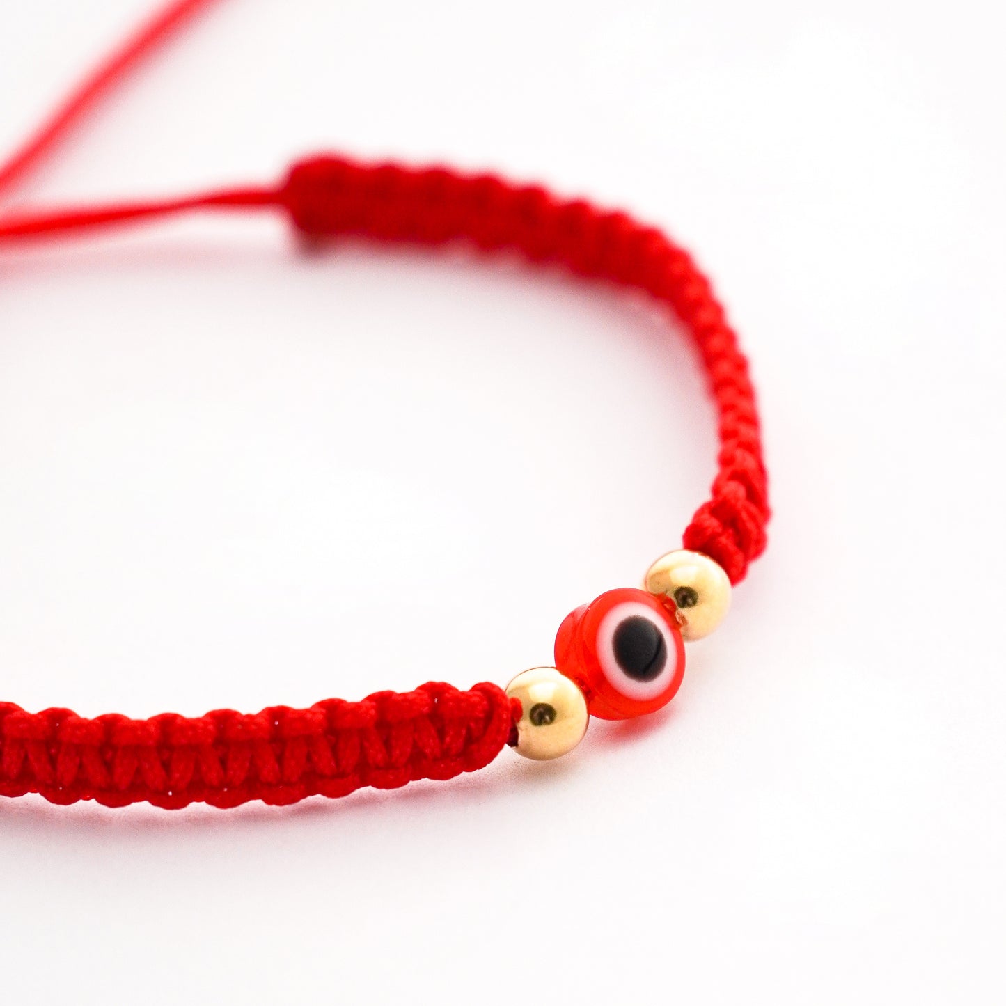Pulsera tejida protectora con ojo turco y 2 bolitas 4 mm en Oro18k