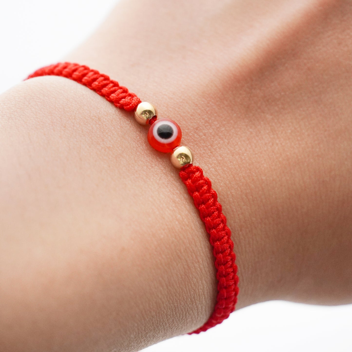 Pulsera tejida protectora con ojo turco y 2 bolitas 4 mm en Oro18k