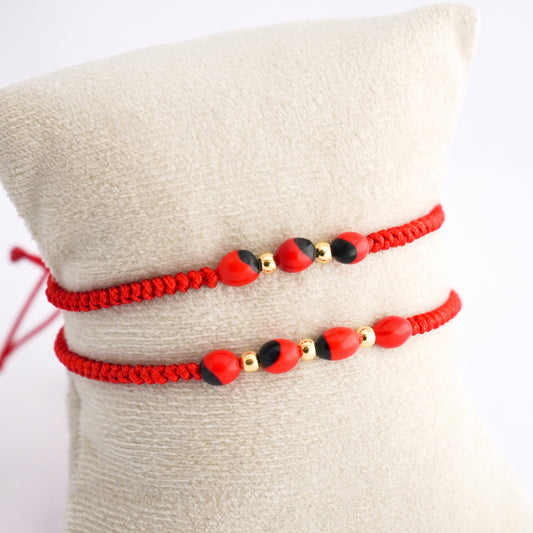 Pulsera tejida con huayruro en Oro18k